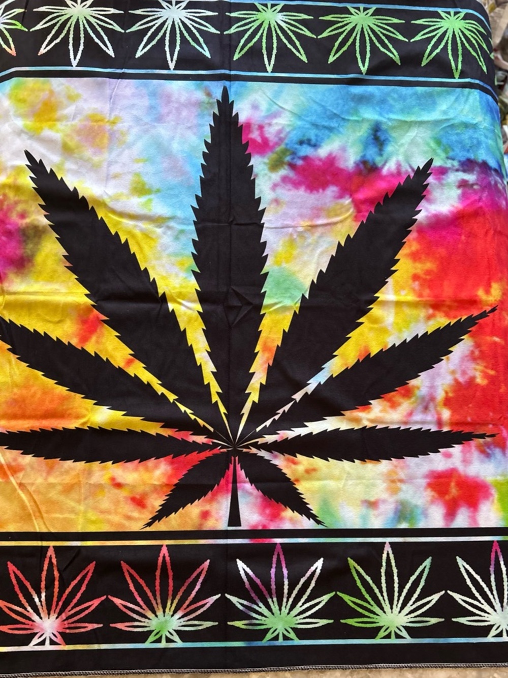 Tie-Dye Cannabis Leaf  - Vibrant Rainbow. Size is. 60” long. 40”. Wide.
